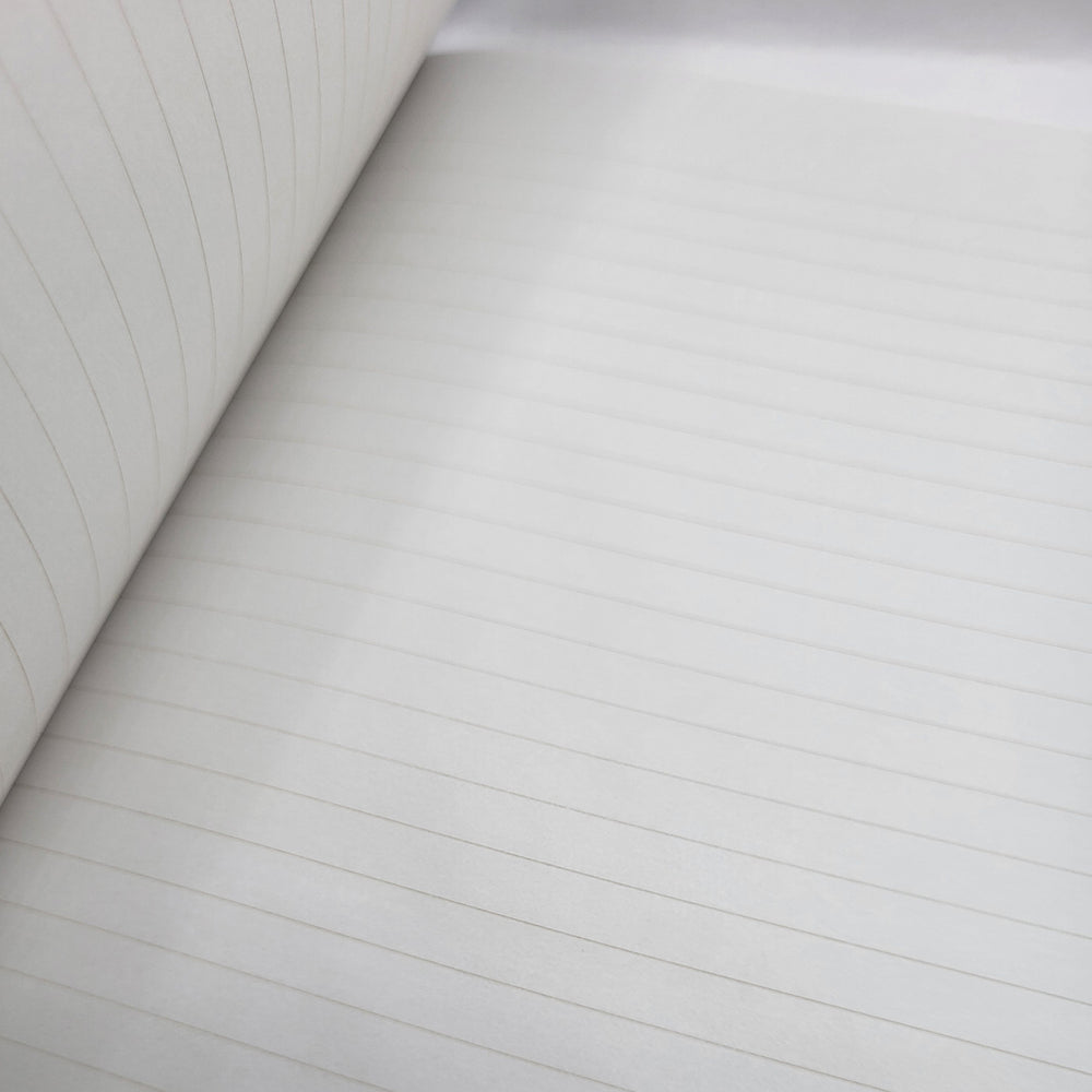 Close-up of lined notebook paper with a focus on texture and lines.