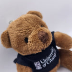 Brown teddy bear keychain with 'University of Glasgow' t-shirt on a white background