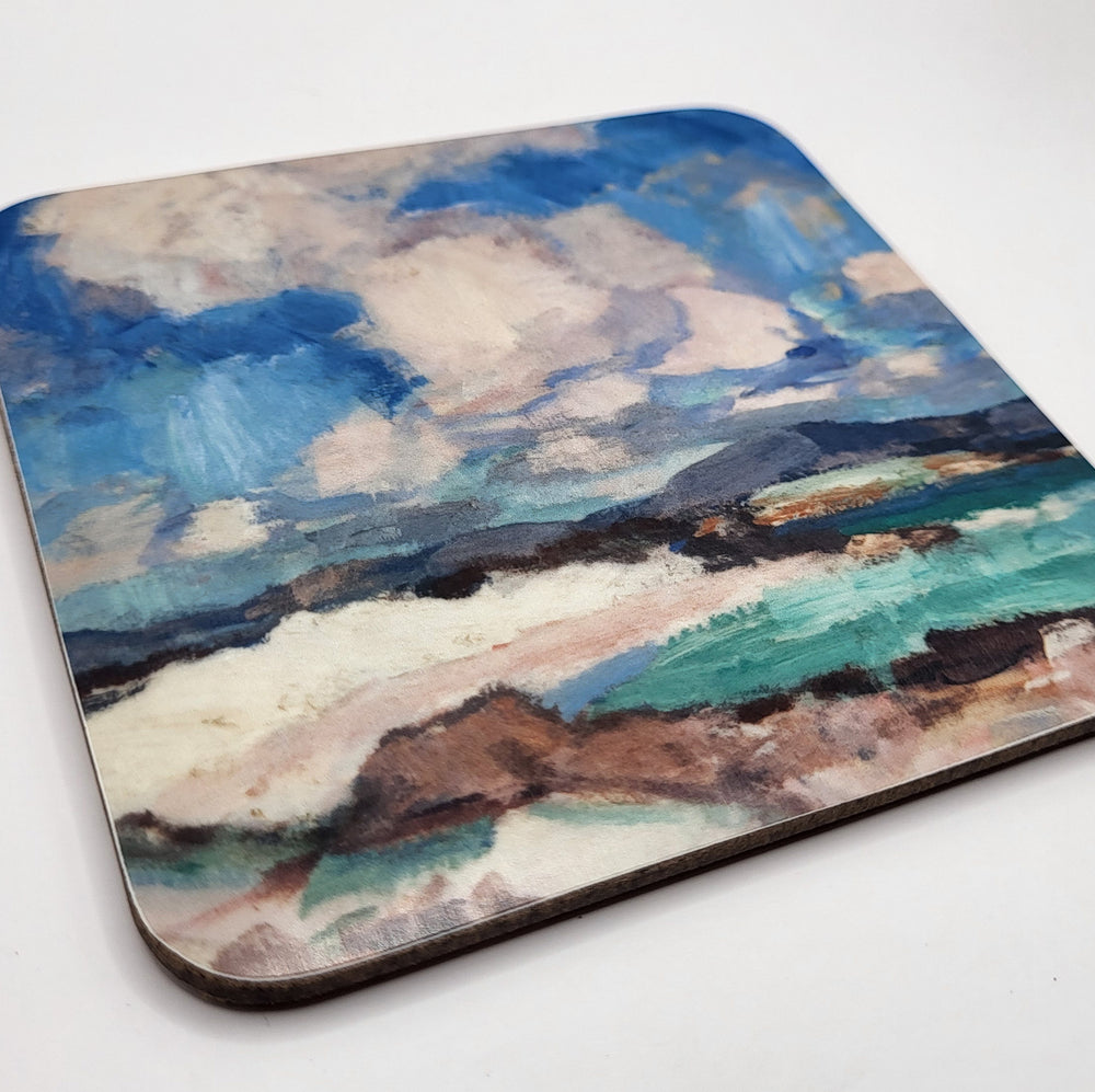 Coaster with a scenic design of mountains and clouds on a white background