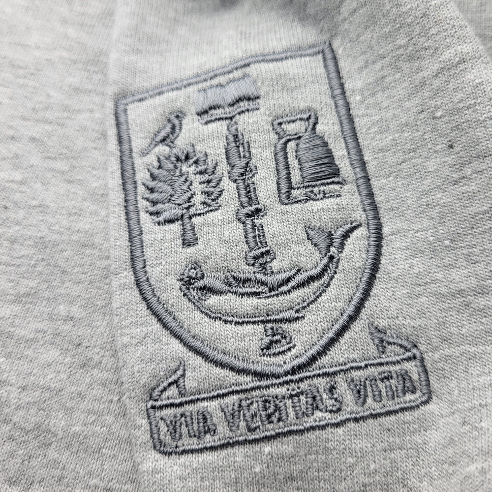 Embroidered crest on a gray sweatshirt with 'Via Veritas Vita' text.