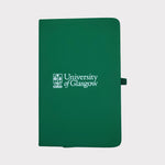 University of Glasgow green A6 Pocket Notebook. The UofG crest is printed in white in the centre of the cover. The notebook has an green closure band and a green ribbon marker.