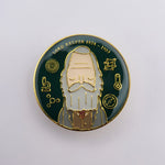 Lord Kelvin Absolute Hero Pin Badge. A round enamel pin badge. The full colour design shows an illustration of Lord Kelvin surrounded by scientific symbols against a dark green background. Lord Kelvin's name and the dates 1824-1907 are written at the top.