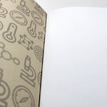 Lord Kelvin Absolute Hero Jotter (inner detail). The image shows part of the inner front cover and part of a blank unlined page. The inner cover is light brown and is printed with a repeating design of scientific symbols in darker brown.