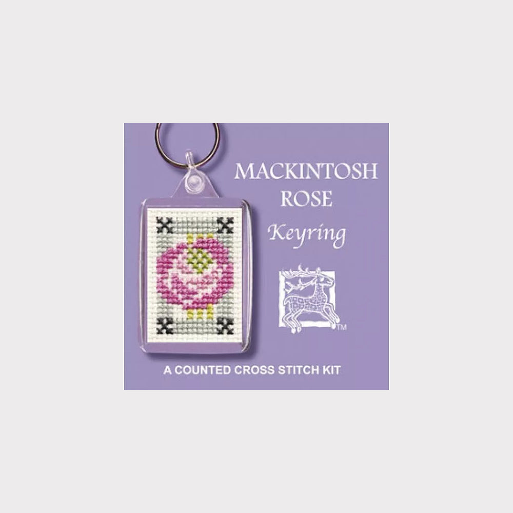 Mackintosh Rose keyring with cross stitch design on a purple background