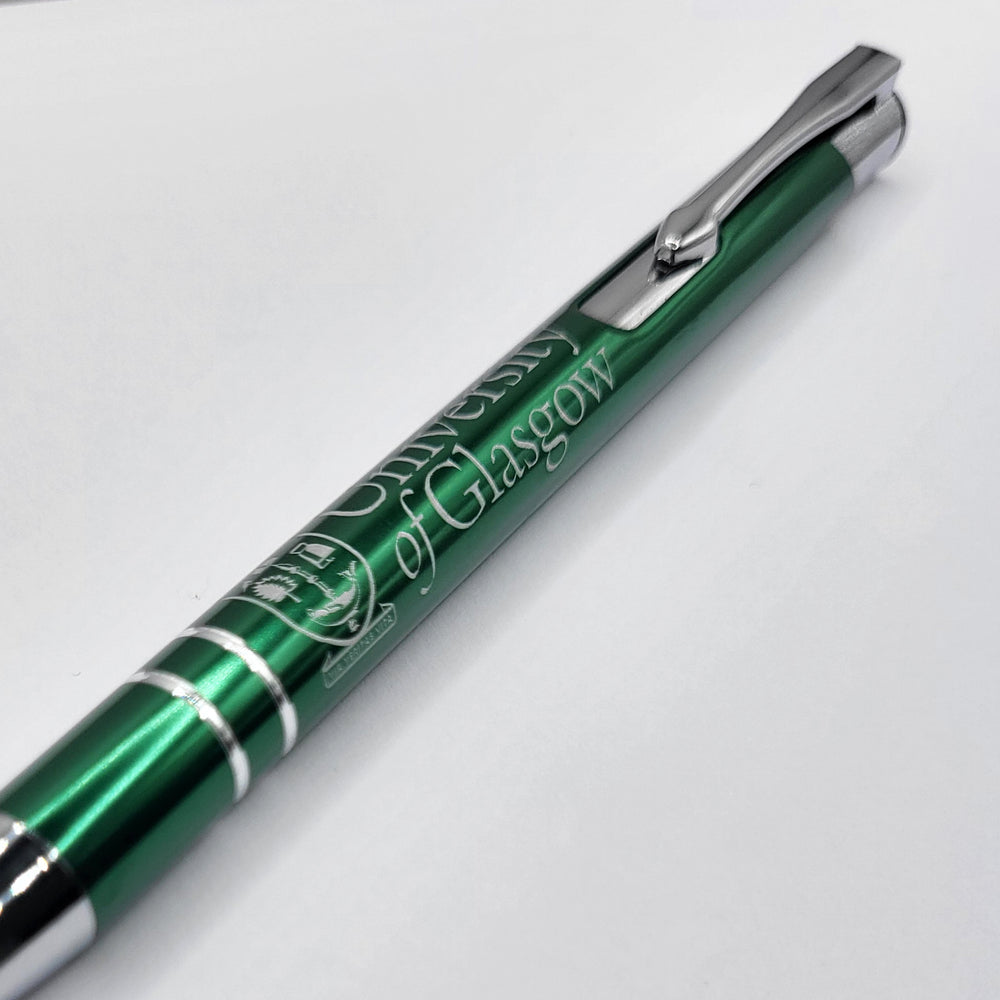 Metal ball point pen with a click top and high-gloss green finish. The UofG crest is printed on the barrel.