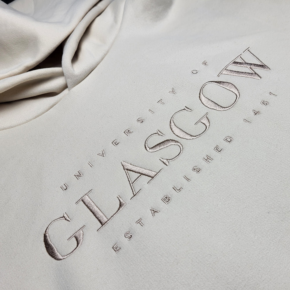 Embossed 'University of Glasgow' text on a light beige fabric background