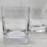 Two clear glass tumblers with 'University of Glasgow' branding on a light gray background