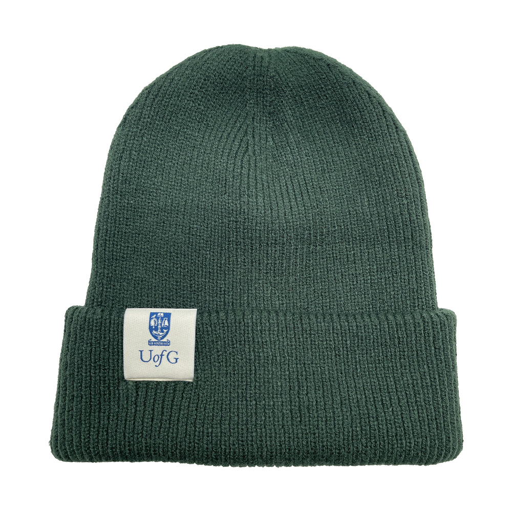 Green beanie with a logo tag on a white background