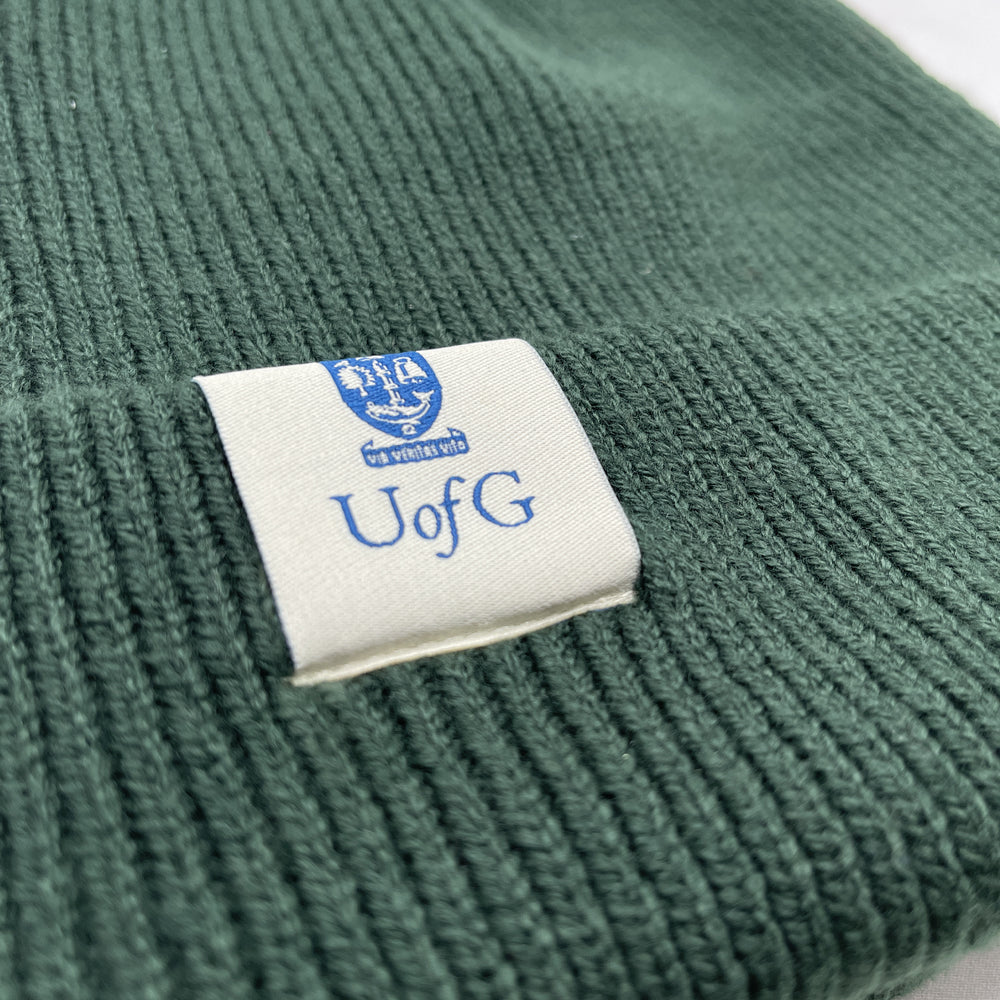 Green fabric with a label featuring 'UofG' text and logo.