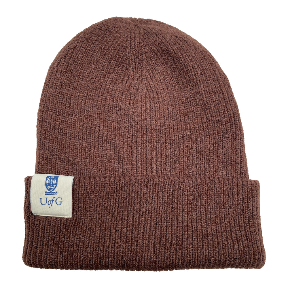 Brown knit beanie with a label on a white background