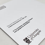 Image shows the reverse of the Rose and Teardrop greetings card. The back of the card is white with the title and other information printed in black. The Hunterian logo and the University of Glasgow crest are also printed in black.