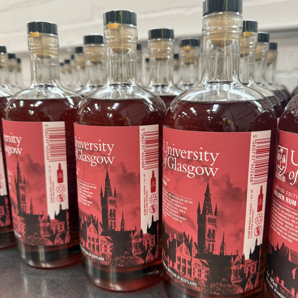 Bottles of University of Glasgow rum with red labels featuring the university's architecture.