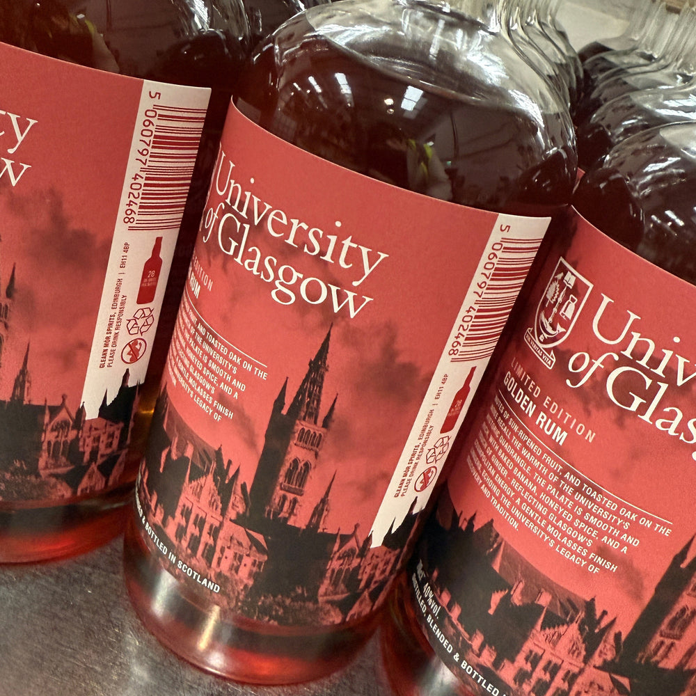 Bottles of University of Glasgow rum with red labels and castle silhouette.