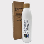 UofG Sugarcane Bottle. The bottle is white with the University of Glasgow crest printed vertically along the side, in full colour. It has a screw-top lid made of bamboo and comes in a recycled cardboard box.