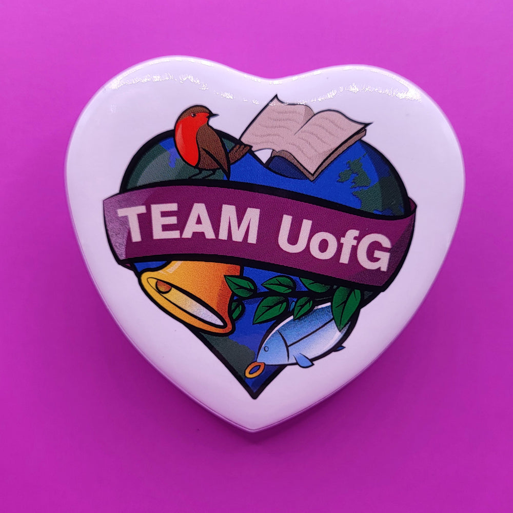 Heart-shaped badge with 'TEAM UofG' design on a purple background