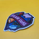 Sticker with 'TEAM UofG' text on a yellow background