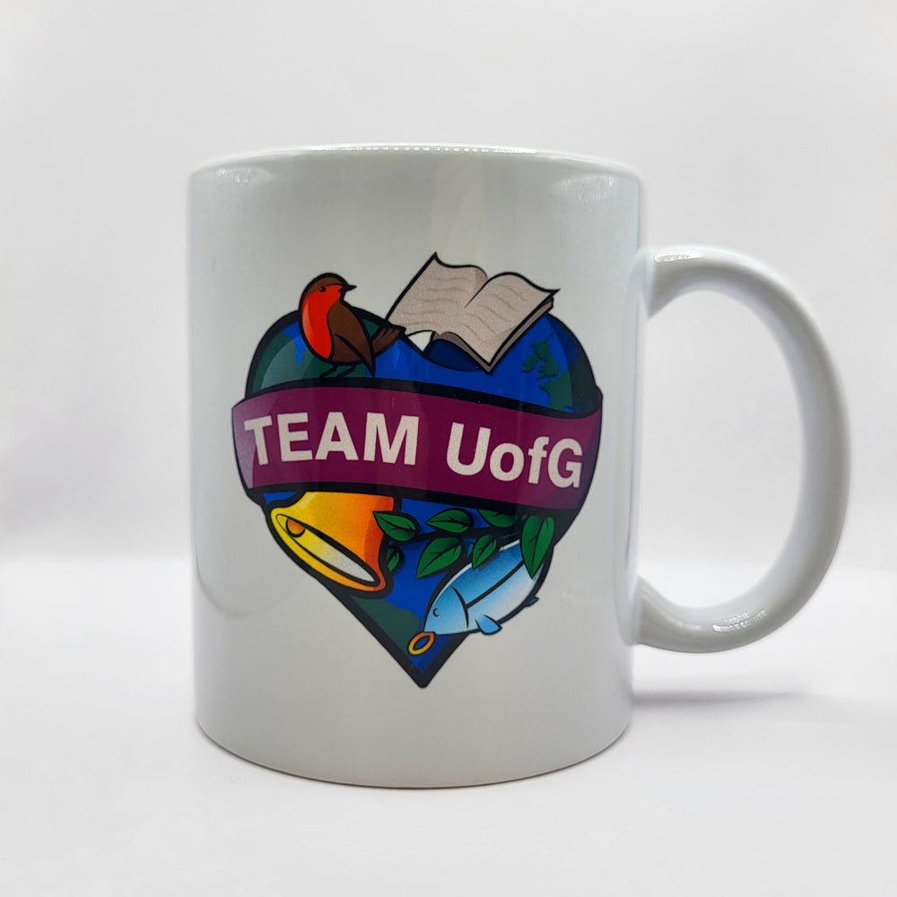 White mug with colorful design and 'TEAM UofG' text on a white background