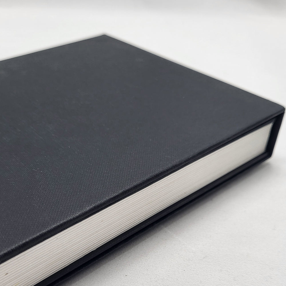 Black bound book on a white background