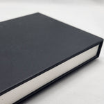 Black bound book on a white background