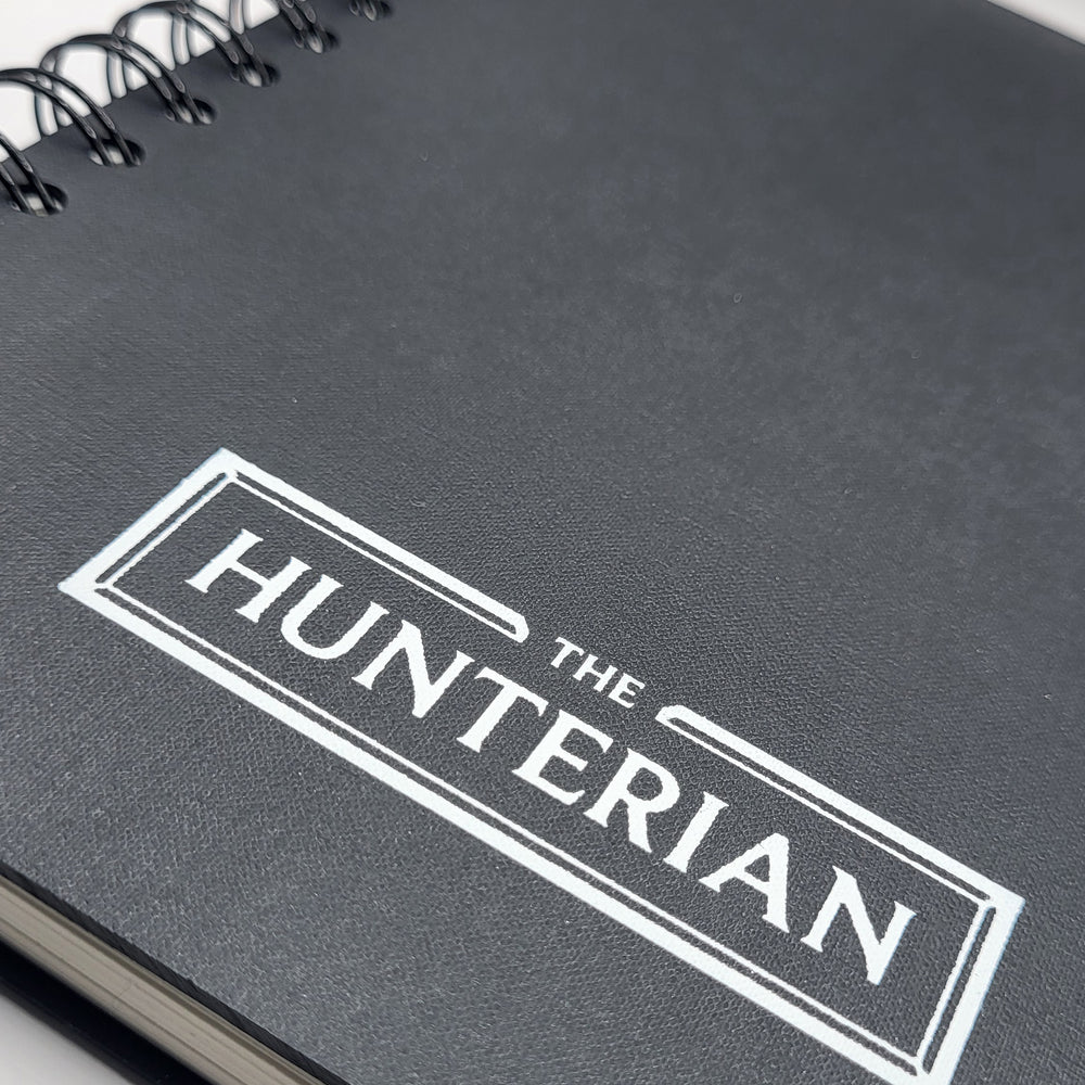 black notebook with 'The Hunterian' logo on a white background