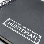 black notebook with 'The Hunterian' logo on a white background