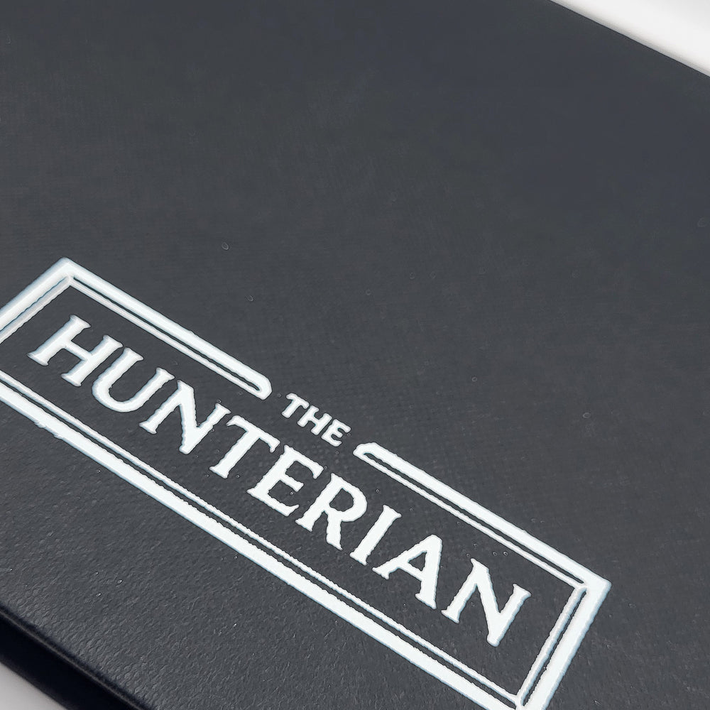 Close-up of a black sketchbook with 'The Hunterian' logo in white.