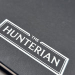 Close-up of 'The Hunterian' logo on a black sketchbook