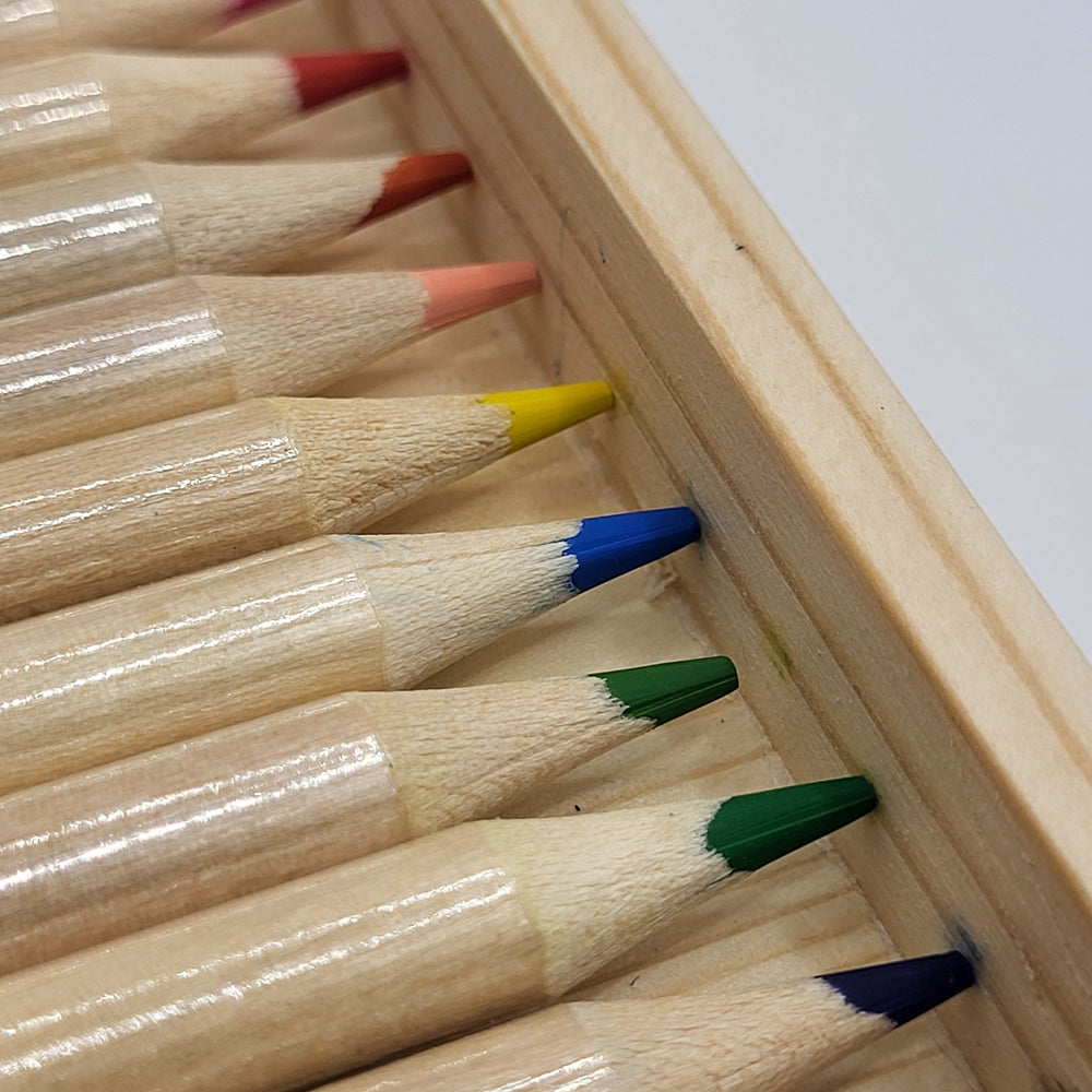 Set of colored pencils with colored tips in a wooden holder.