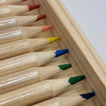Set of colored pencils with colored tips in a wooden holder.