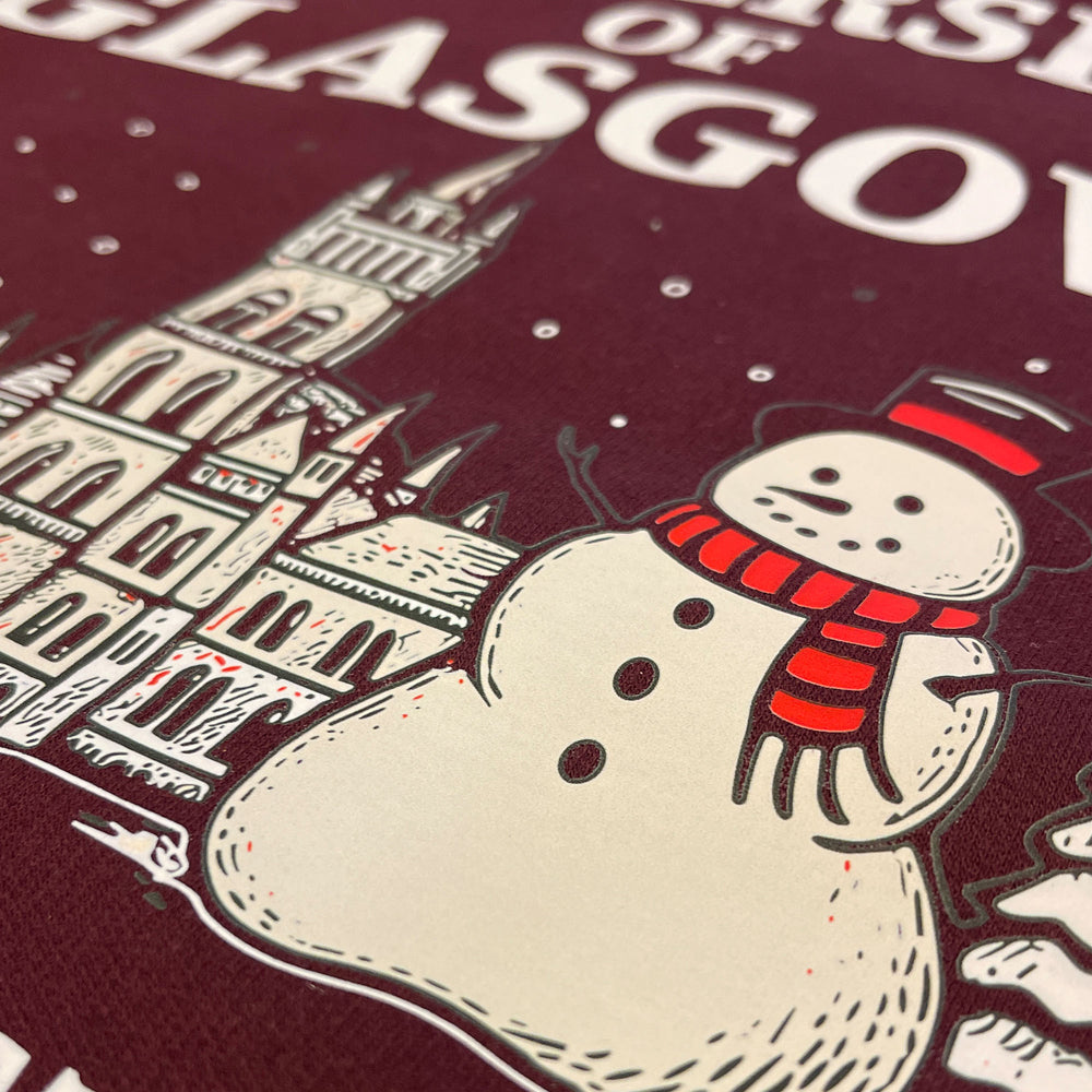 Snowman with a red scarf and a building illustration on a maroon background with 'Glasgow' text.