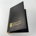Passport cover (outer sleeve). Plain black with the University of Glasgow crest printed in gold in the lower centre.