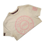 University of Glasgow Organic Cotton Circle T-Shirt in stone neutral. The image shows the t-shirt folded in half. There is a circle design printed in pale pink on the chest. The UofG crest is printed in pale pink on the left sleeve. The circle design consists of the words "University of Glasgow" in block capitals, with the date 1451 in the middle.