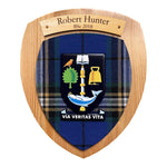 Personalised University of Glasgow Tartan Plaque in Light Wood. Made with official UofG tartan, full colour raised crest, and light wooden name plate. There are two lines of example text on the plate. The top line reads: "Robert Hunter" . The second line reads: "BSc 2018".